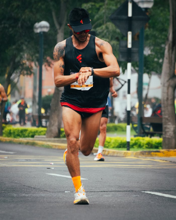 Athlete checks watch while running a marathon in Peru, showcasing focus and endurance.